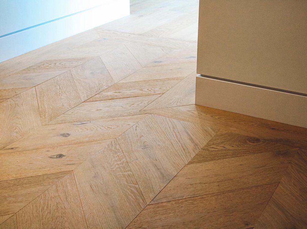 Laminate vs Hardwood Flooring: Which To Choose? 2 Freshly installed hardwood flooring in a Sea to Sky home by Tantalus Floors