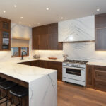 Hardwood Flooring in Whistler 1 White oak hardwood flooring in a Whistler kitchen with walnut cabinetry and marble — Tantalus Floors